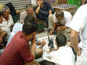 thailand-26-006 When it comes to bottlecap checkers on homemade cardboard platforms, don't mess with the Malaysians